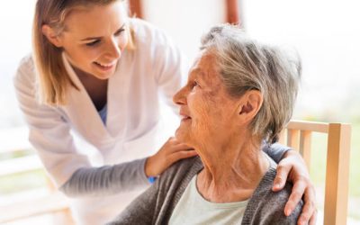 Health visitor and a senior woman during home visit. A nurse talking to an elderly woman.